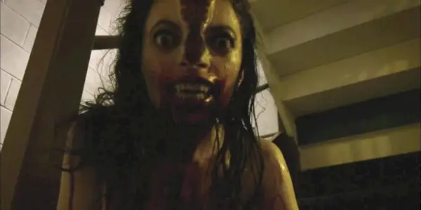 Still from V/H/S: A woman transforms into a monster with her head splitting in two.