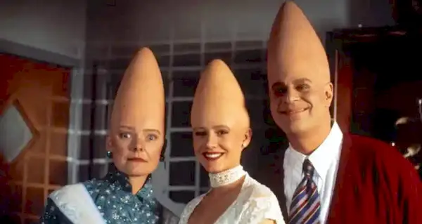 Prymatt, Connie and Beldar Conehead standing together smiling in Coneheads.