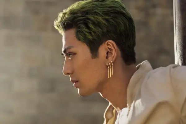 Roronoa Zoro in One Piece with green hear and a triple earring