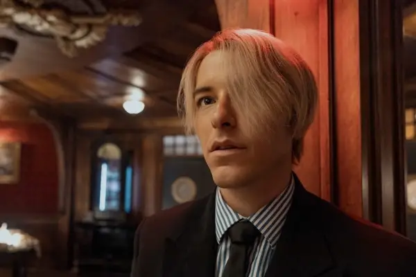 Sanji in One Piece wearing a stripy shirt, tie and blazer