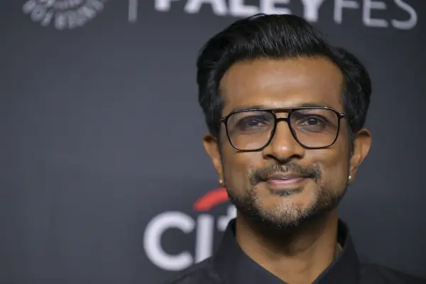 Utkarsh Ambudkar wearing a black shirt and glasses
