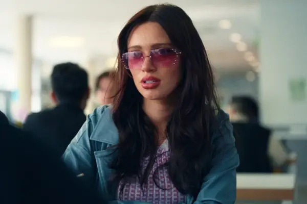 Alison sat opposite Mia in the school cafeteria wearing a leather jacket and sunglasses