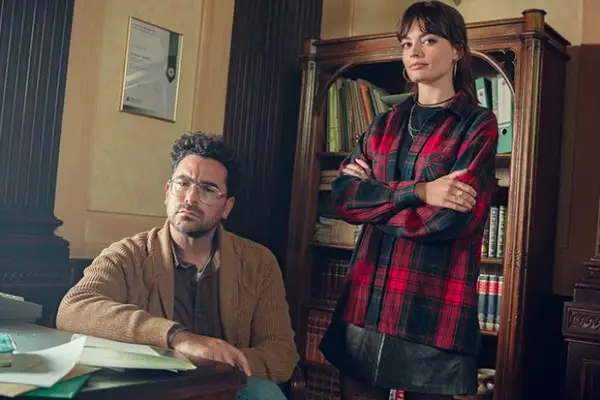 Dan Levy and Emma Mackey in Sex Education season 4 next to each other, looking into camera