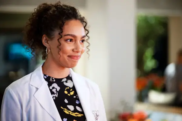 Ruby at the lab wearing a white lab coat and smiling