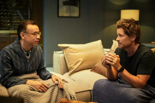 lesley and ellis sat on different sofas opposite one another talking