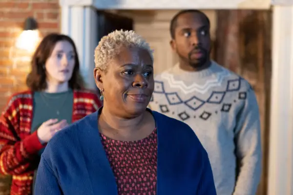 Betty outside with daughter-in-law Alison and son Mike standing behind her