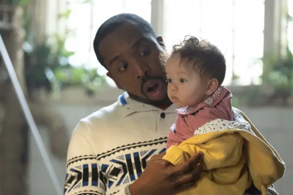 Mike (Kiell Smith-Bynoe) holds baby Mia in Button House