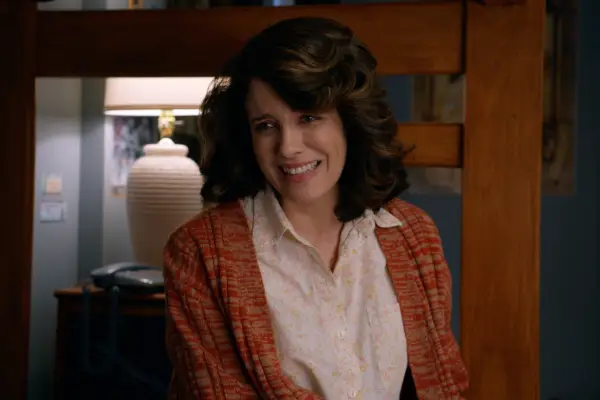 Alanna Ubach as Susan Bennett wearing a shirt and cardigan in Ted
