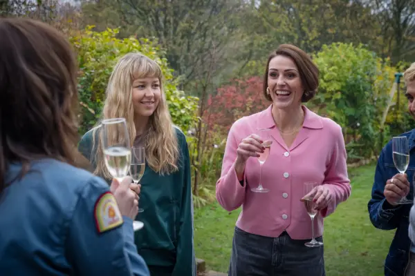 Liv Hall as Izzie and Suranne Jones as Suz in Film Club. They are both holding champagne flutes.