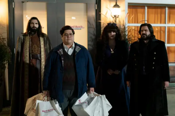 Kayvan Novak as Nandor, Harvey Guillén as Guillermo, Natasia Demetriou as Nadja and Matt Berry as Laszlo in What We Do in the Shadows gathered outside a house