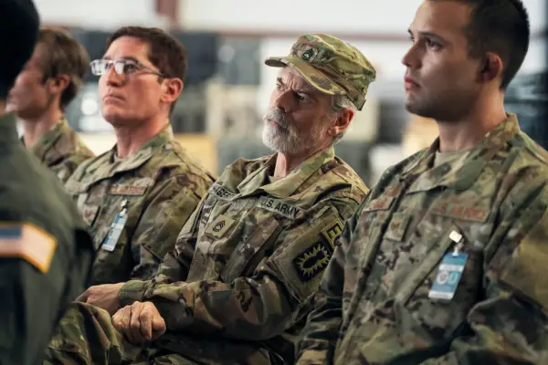 Haggerty dressed in his army uniform, sat down at base, listening to a presentation