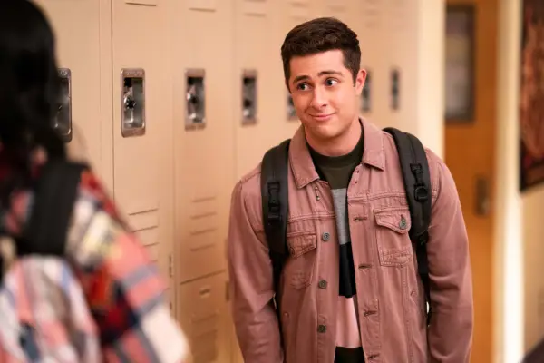 Ben standing by his locker talking to Devi