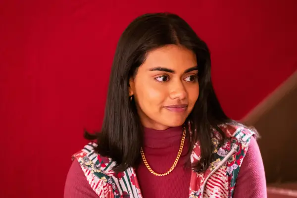Closeup of Aneesa stood in front of a red wall