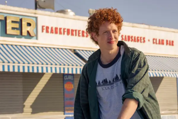 Nicole Ari Parker plays Lisa Todd Wexley, sat at a desk with Central Park behind her, wearing a colourful blouse