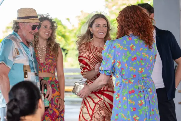 Geoff Bell as Gerry Stableforth, Amelia Clarkson as Mariana and Patsy Kensit as Bella in Death in Paradise shaking hands.