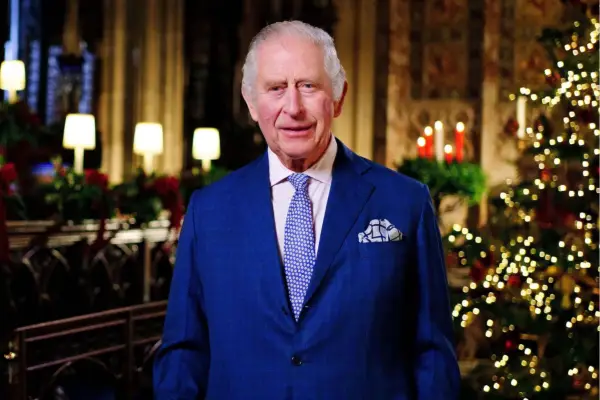 Toby Jones as Alan Bates in Mr Bates vs the Post Office standing next to a sign reading 