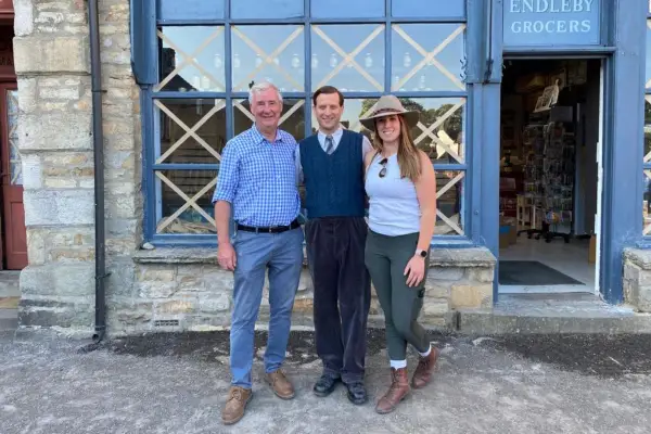Cast from All Creatures Great and Small and The Yorkshire Vet standing outside a building