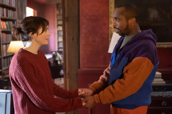 Charlotte Ritchie and Kiell Smith-Bynoe in Ghosts holding hands