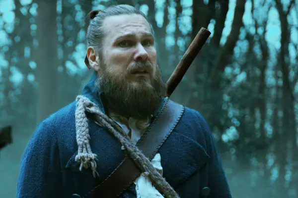 Moose Pleck standing in the forest with an anxious expression on his face