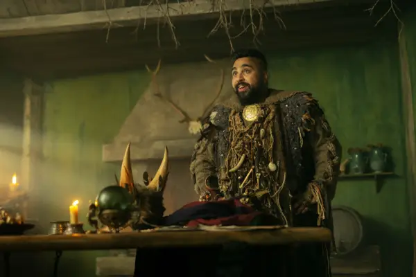 Helen Gwinear wearing period dress, standing in a doorway with Turpin and Nell behind her