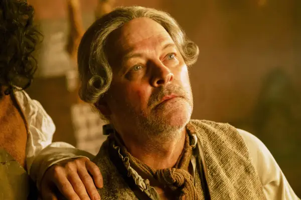 John Turpin sat down while talking to someone