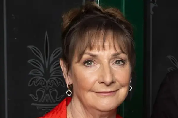 Pauline McLynn as Maggie Driscoll in close-up in a red blazer for Coronation Street.