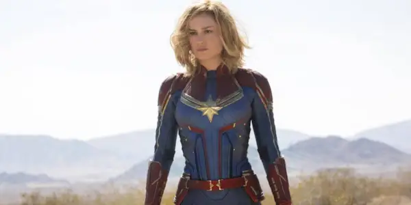 Brie Larson as Captain Marvel standing in the desert in Captain Marvel.