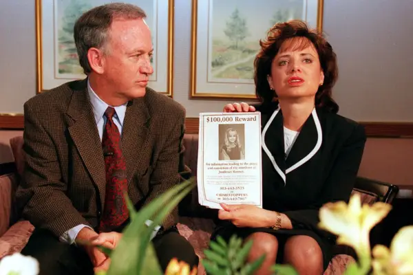John and Patsy Ramsey sat next to each other, with Patsy holding up an image of their daughter JonBenet.