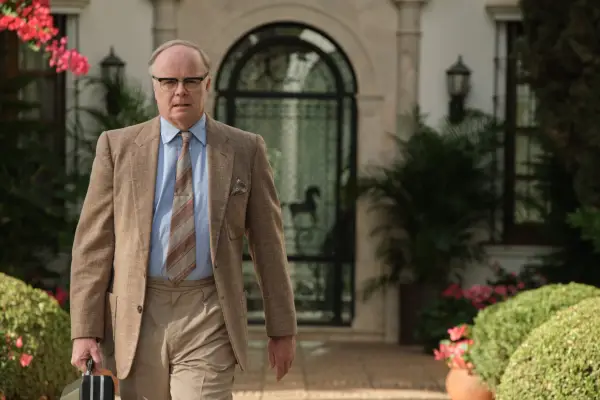 Ian Puleston-Davies as Pender in Archie wearing a suit and top hat in the middle of a circus show.