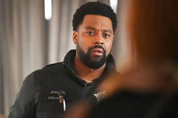 LaRoyce Hawkins as Kevin Atwater standing talking to someone, wearing his police uniform