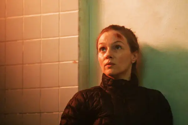 Tracy Spiridakos as Hailey Upton in Chicago PD, sat on the floor, with a cut on her head