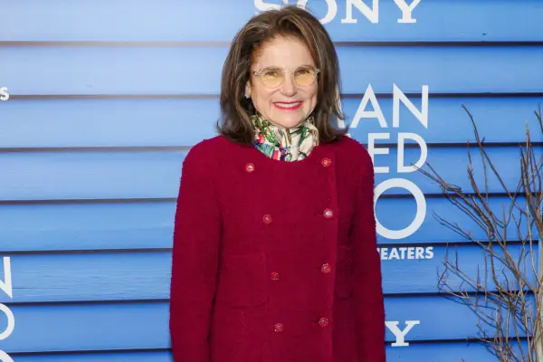 Tovah Feldshuh on the red carpet for A Man Called Otto, wearing a red coat
