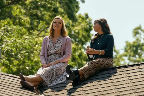 Missi Pyle as Hannah and Constance Zimmer as Shira Bolitar sitting on a roof talking in Harlan Coben