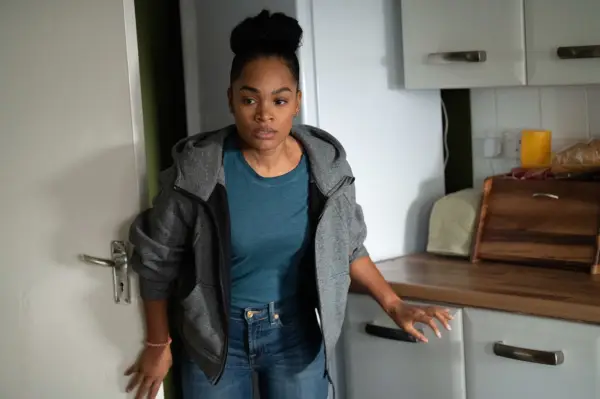 Tahirah Sharif as PC Lizzie Adama in The Tower 2: Death Message wearing a black jacket and blue shirt, looking stressed