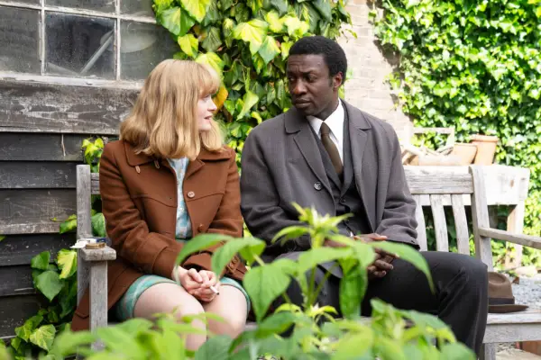 Natalie Quarry as Rosalind and Zephryn Taitte as Cyril, sat facing one another while sat on a bench