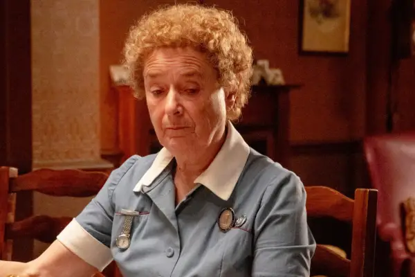 Nurse Crane sat the table eating breakfast looking glum