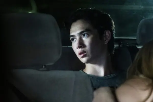 Steven sat in the back seat of a car looking out the window