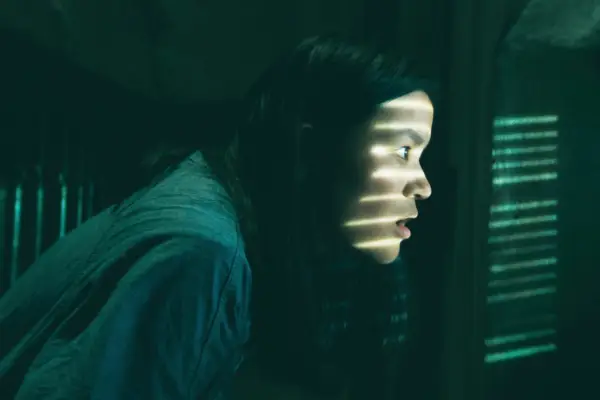 Sydney Topliffe as Abbie, looking through a vent