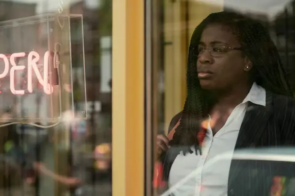Uzo Aduba as Edie Flowers, looking out of a window