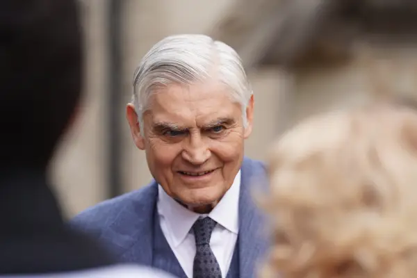 Jack smiling outside the church, dressed in a suit