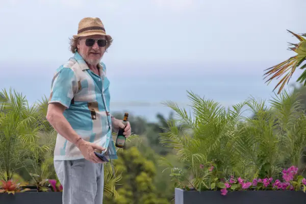 Geoff Bell plays Gerry Stableforth, standing by the pool with a drink in his hands