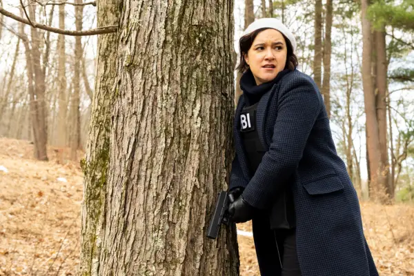 Keisha Castle-Hughes as Special Agent Hana Gibson standing next to a tree