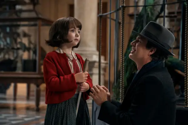 Nell Sutton as Young Marie-Laure and Mark Ruffalo as Daniel LeBlanc in All the Light We Cannot See, with Daniel smiling as Marie-Laure holds a stick