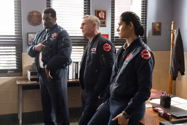 Wallace Boden, Christopher Herrmann and Stella Kidd stood in a line, being spoken to, in their work overalls