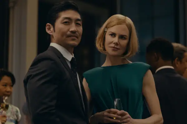 Clarke (Brian Tee) and Margaret (Nicole Kidman) stand next to each other in formalwear at an event