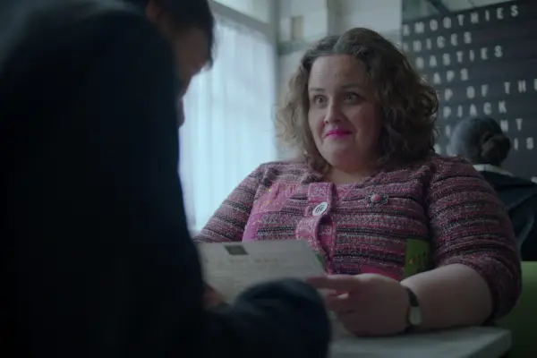 Jessica Gunning as Martha smiling and looking at Donny while holding a restaurant menu and sitting down facing each other.