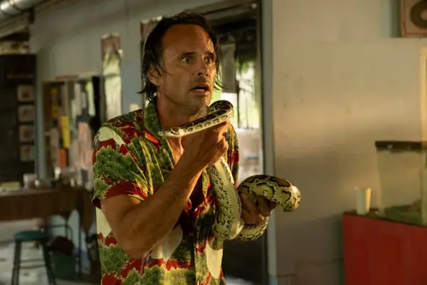 Walton Goggins as Rick Hatchett holding a snake in The White Lotus season 3.