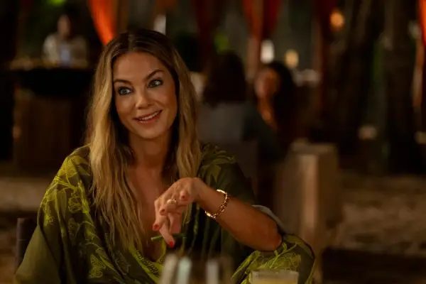Michelle Monaghan as Jacyln Lemon sat at a table in The White Lotus season 3.