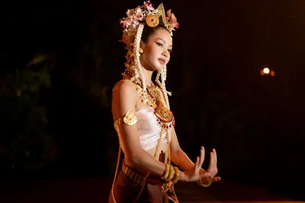 Lalisa Manobal performs in a headdress and dress as Mook in The White Lotus season 3.