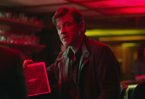 Adam Rothenberg as Mel Sattem holding a CCTV image in Ozark